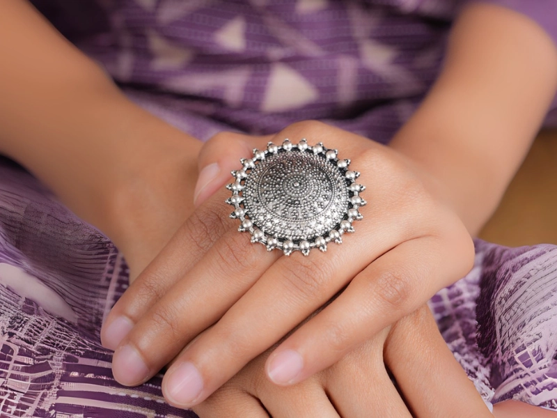 Elegant flatlay of oxidised jewelry including layered necklaces, jhumkas, bangles, and rings styled with ethnic and Western outfits – perfect for every occasion 8