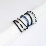 Pack of six black beaded bracelets, black with gold and grey accents, and striped beaded stretch bracelets.