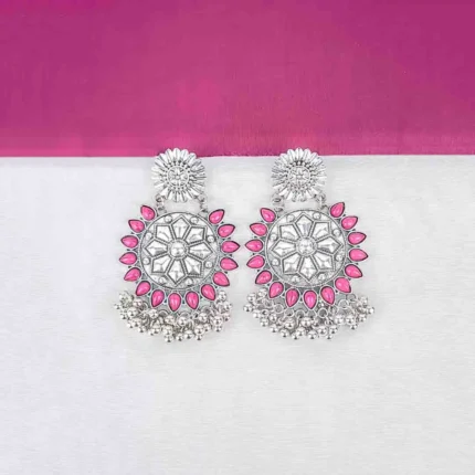 Large, two-tiered oxidized silver stud earring. The top tier is a floral stud, and the main disc tier features an intricate Mandala or geometric pattern, dramatically framed by an outer border of magenta enameled teardrop shapes with small metallic beads dangling below.