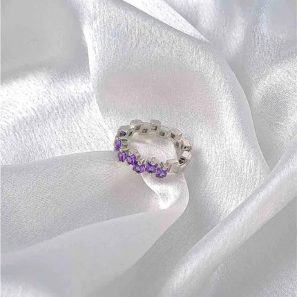Two geometric silver rings in purple and pink colours.