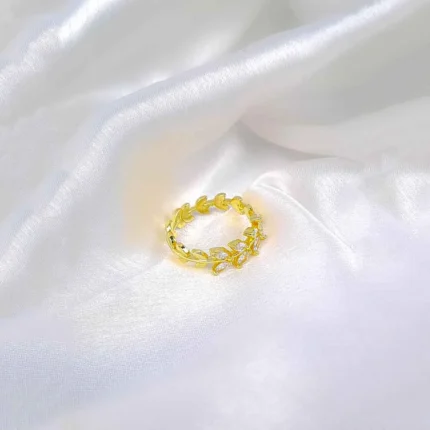 Gold adjustable ring with polished leaf motifs and open band.