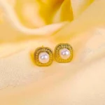 Gold textured pearl stud earrings with polished finish and push‑back closure for a classic, vintage‑inspired look.