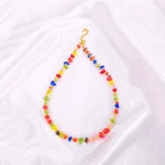 Boho-style necklace with multicolor chip stone beads and gold spacers and lobster clasp.