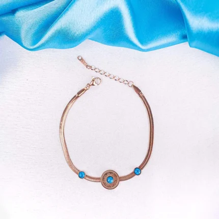"Rose gold bracelet with blue stones and adjustable sliding clasp. "