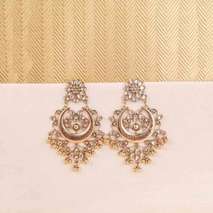 Gold-toned crescent chandelier earring with Kundan detailing, enamel accents, and hanging bead embellishments.
