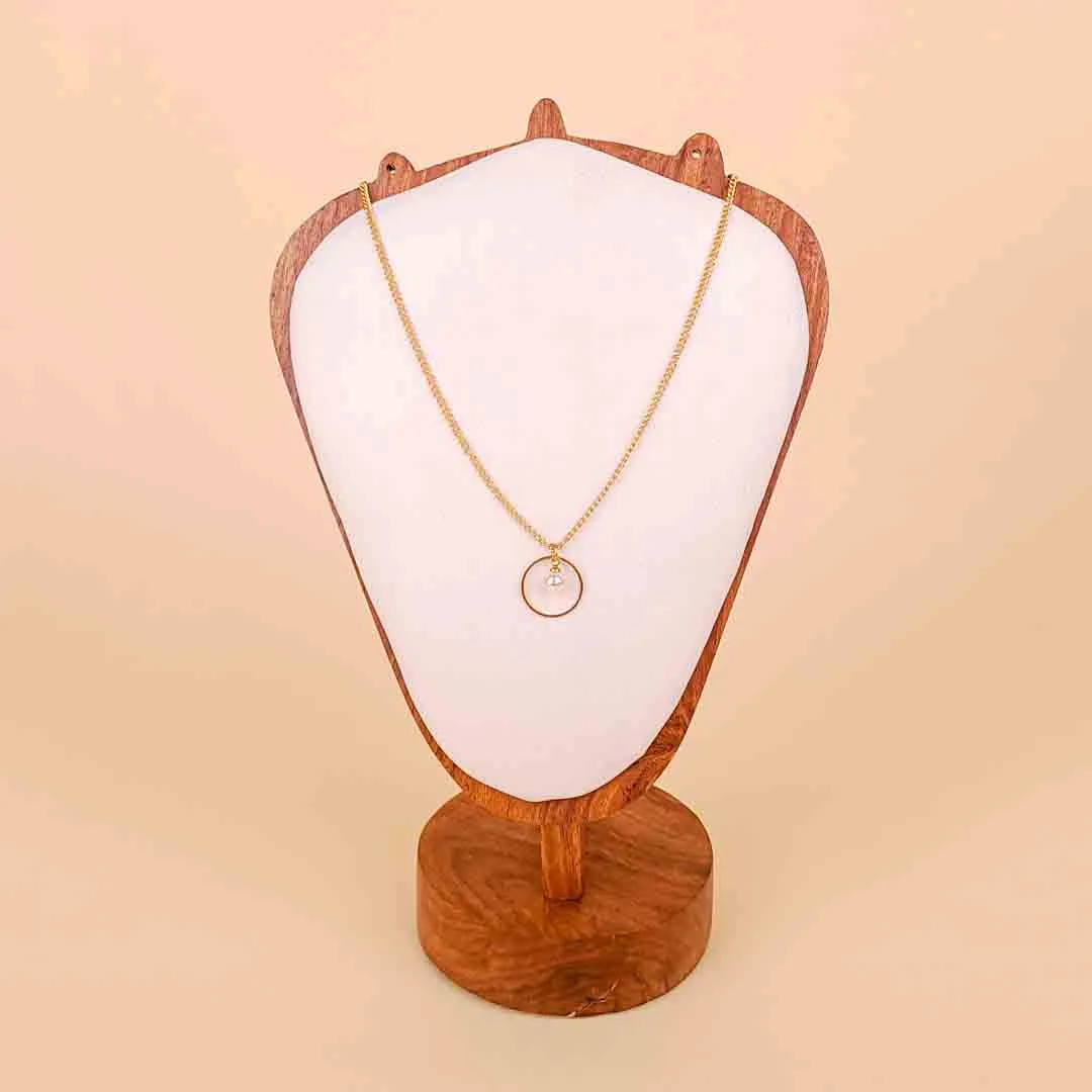 20251121_102448 (1) A delicate, gold-toned chain necklace featuring a single round pendant: a faux pearl suspended in the center of a thin, open, circular gold frame.