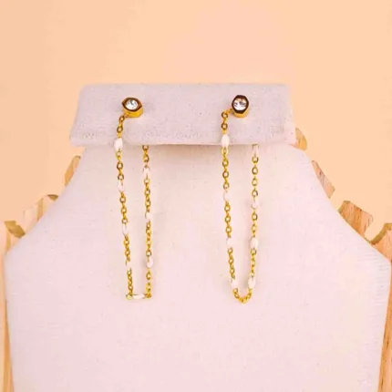 Gold drop earring featuring tiny white beads and a crystal top.