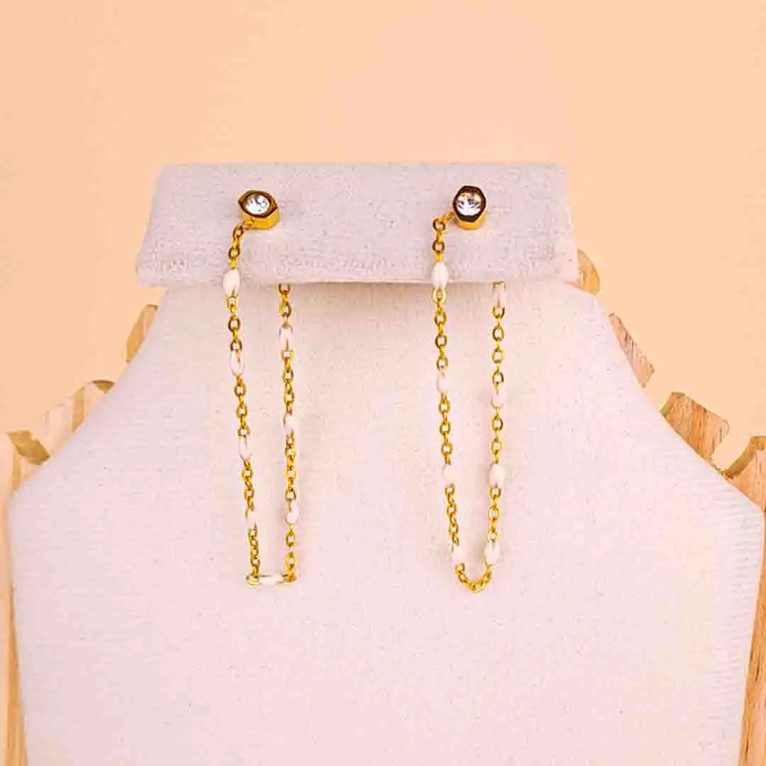 20251121_113602 (1) Gold drop earring featuring tiny white beads and a crystal top.