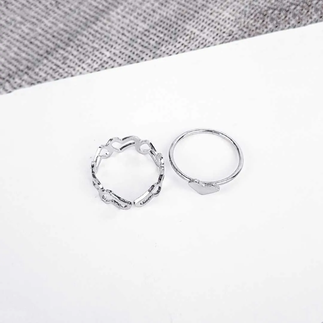 20251121_115755 An open, adjustable silver-toned ring featuring a repeating, delicate pattern of interconnected heart shapes, another with heart in middle ideal for stacking.