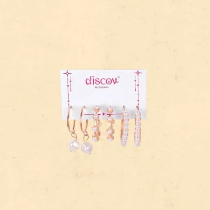 Collection of five pairs of gold-toned stud earrings, including bow shapes, textured flower studs, simple pearl domes, tiny gold balls, and clustered micro-bead designs.