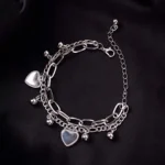 Silver dual-layer bracelet with curb chain charms and gauge wire chain, secured with lobster claw clasp.