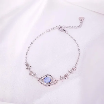 Silver-tone bracelet with blue oval stone and crystals, fine chain and secure clasp.