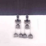 Traditional oxidized jhumka earrings featuring black stone studs and layered triple jhumkis.