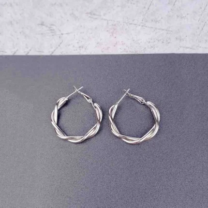 "Silver double hoop earrings with bold ball studs and polished finish, featuring secure push-back closure. "