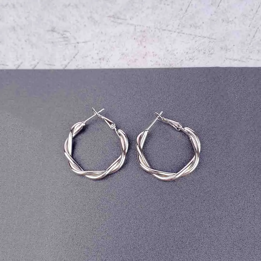 th - 2026-01-28T142107.890 "Silver double hoop earrings with bold ball studs and polished finish, featuring secure push-back closure. "