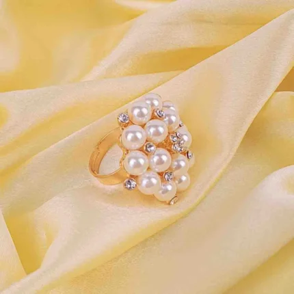 Cocktail ring with clustered pearls and rhinestones on gold-tone adjustable band.