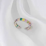 Silver-tone open ring with multicolour faceted gemstones in a gradient layout and adjustable fit.