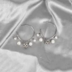 Silver hoop earrings with dangling pearls and crystal charms, polished finish, and push-back closure for elegant style.
