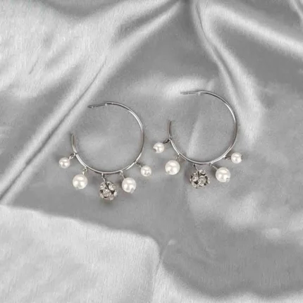 Silver hoop earrings with dangling pearls and crystal charms, polished finish, and push-back closure for elegant style.
