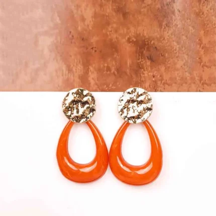 "Gold hammered disc earrings with brown resin teardrop drops, polished textured finish, and push-back closure. "