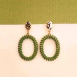 "Green and gold chunky spiral hoop earrings with a polished finish and push-back closure, offering a trendy statement style. "