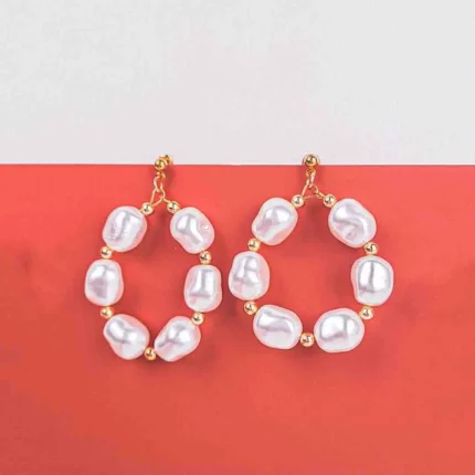 Hoop earrings with baroque pearls and gold-tone beads, featuring polished finish and push-back closure.