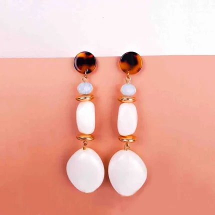 "Tortoise shell stud earrings with blue bead, gold detail, and white organic-shaped stone dangles, finished with a polished closure. "