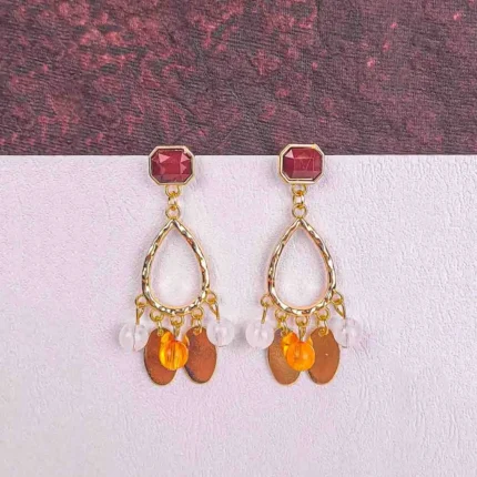 Gold teardrop dangle earrings with faceted gemstones and mixed beads, finished with a textured frame and post-back closure.