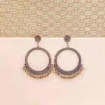 Oxidized golden Chandbali earrings with crescent-shaped hoops, ghungroo detailing, and floral stud top, perfect for festive occasions and weddings.