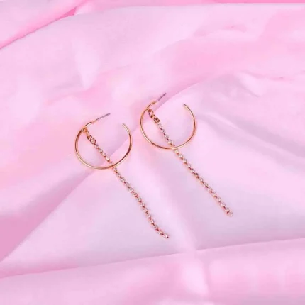 Gold hoop earrings with rhinestone chain drops, featuring polished half hoops and cascading crystals.