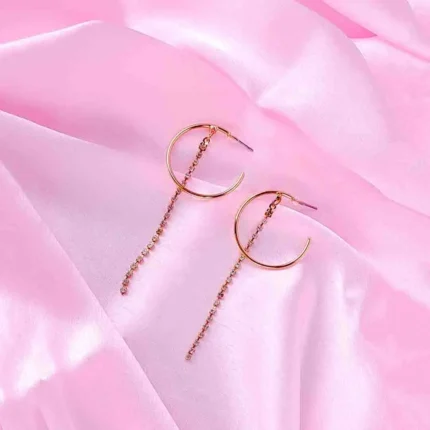 Gold hoop earrings with rhinestone chain drops, featuring polished half hoops and cascading crystals.