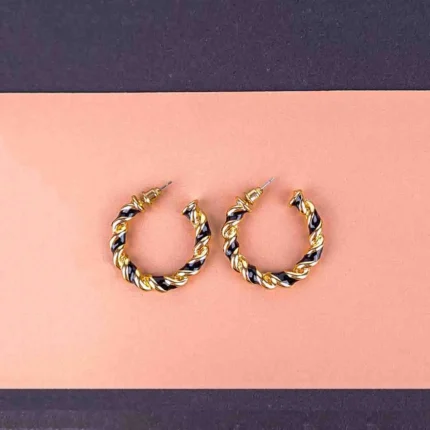 Twisted gold and black hoop earrings with textured finish and push-back closure.
