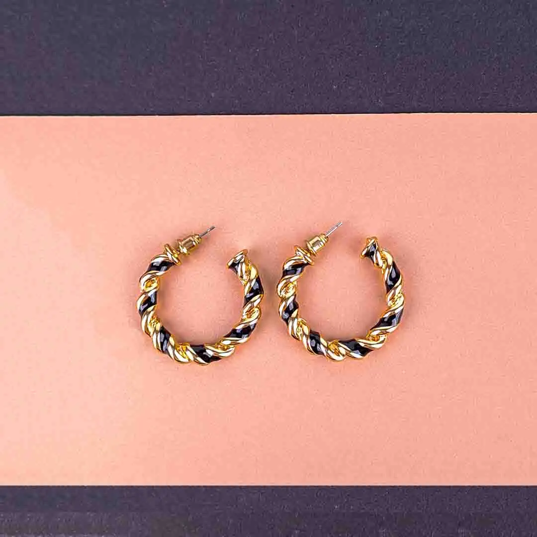 20251106_121826 Twisted gold and black hoop earrings with textured finish and push-back closure.