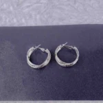 Textured silver hoop earrings with a polished finish and secure push-back closure.