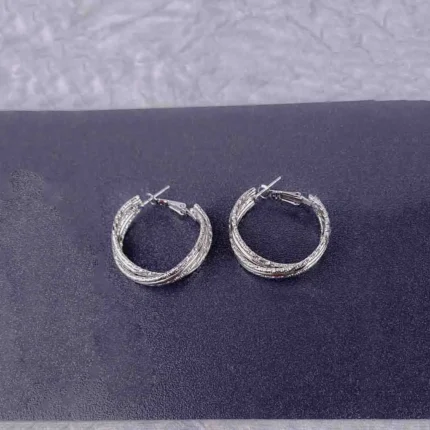 Textured silver hoop earrings with a polished finish and secure push-back closure.