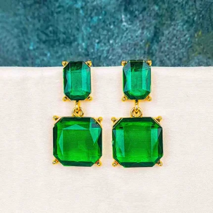 Drop earrings with rectangular faceted emerald-toned stones, polished prong setting, and push back posts.